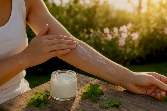 Person applying after sun lotion on arm outdoors
