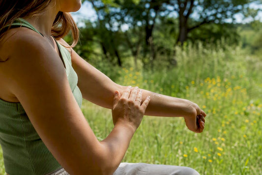 Applying soothing balm on forearm outdoors
