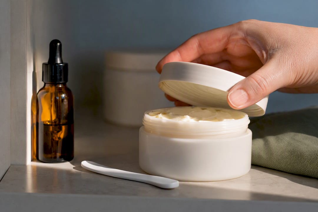 Anonymous body butter jar on storage shelf