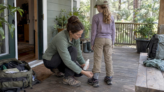Parent checks family clothing before an outing