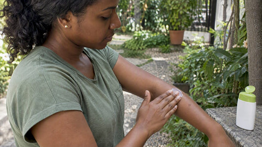 Applying sunscreen to a healed mosquito-bite mark