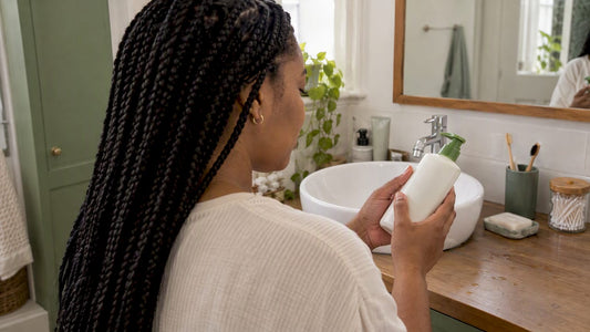 Woman checking a lotion bottle label